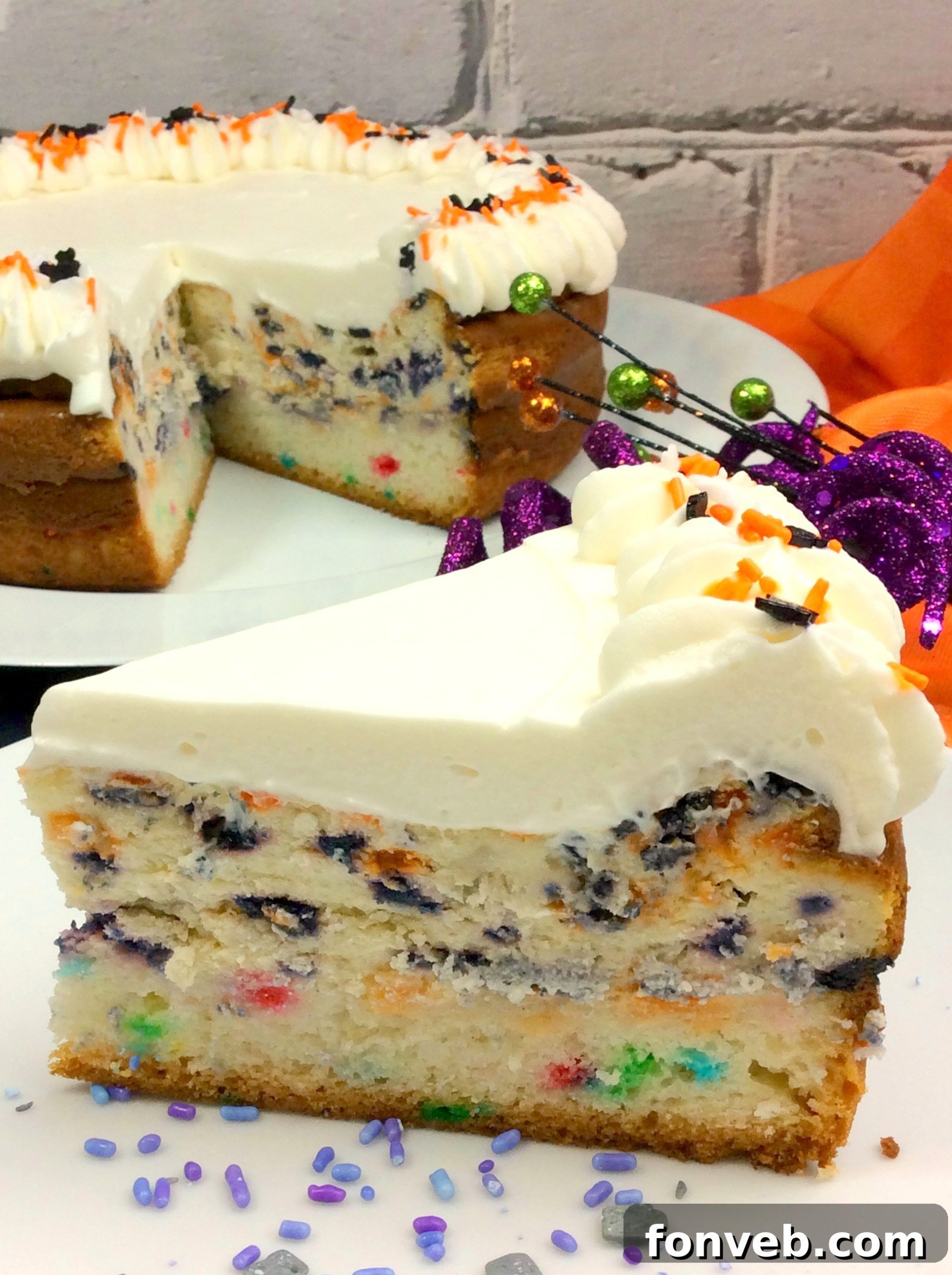 Close-up of a festive Halloween Funfetti Cheesecake, showcasing its creamy texture and sprinkle topping