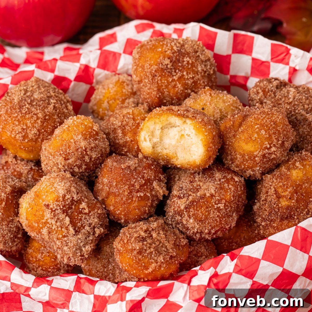 Apple Pie Donut Holes in a basket with a checked parchment paper in basket