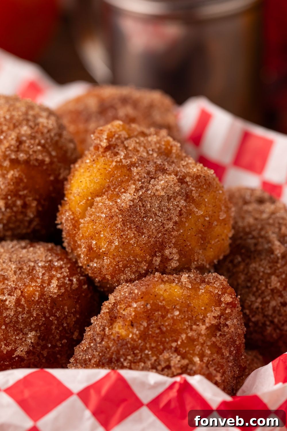 close up look of Apple Pie Donut Holes in a basket sitting on a table 