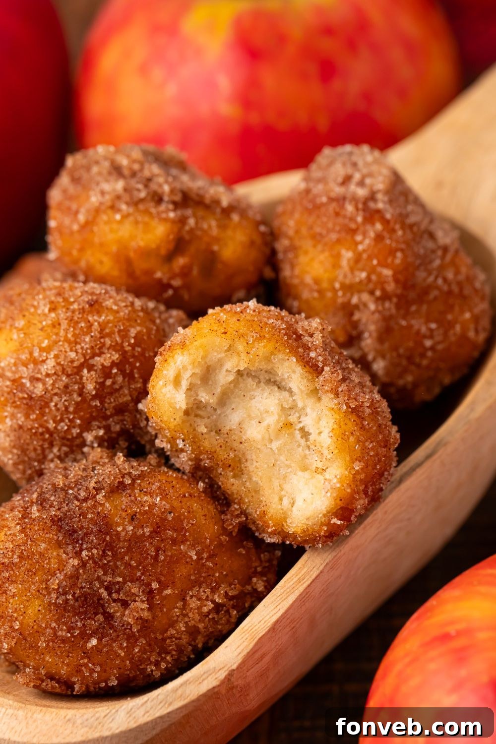 Apple Pie Donut Holes in a basket with a red checked liner sitting on a wooden table