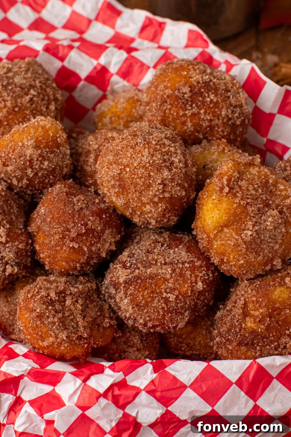 close up of Apple Pie Donut Holes in a red checkered basket