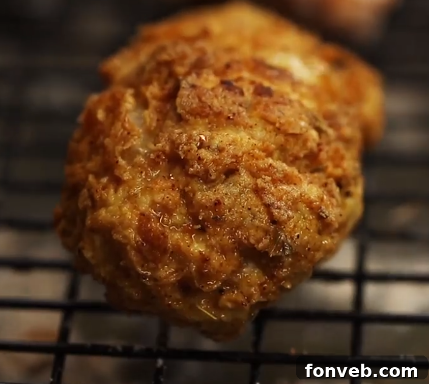 Close-up of crispy fried chicken pieces stacked on a plate