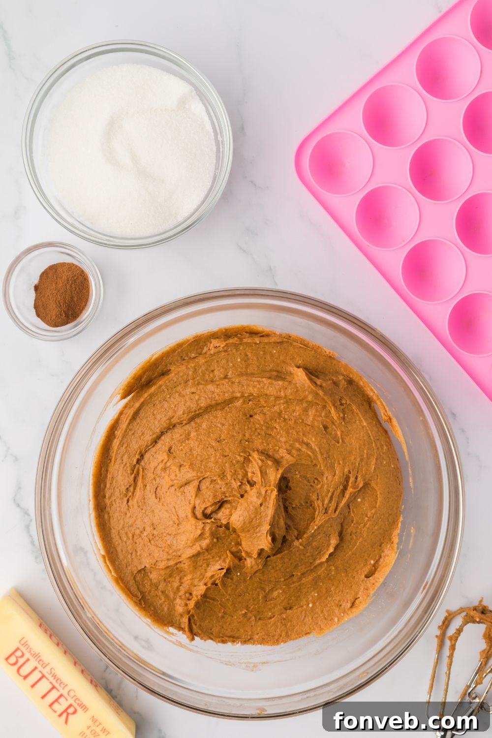 Cinnamon Sugar Baked Pumpkin Spice Donut Holes 7 a glass bowl with Pumpkin Spice Donut Hole batter in it, with the donut pan to the side