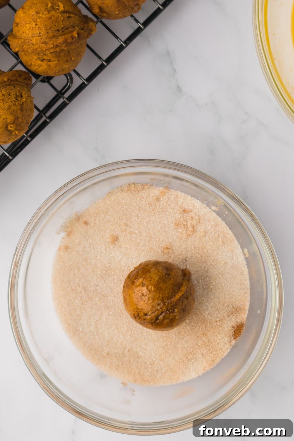 Cinnamon Sugar Baked Pumpkin Spice Donut Holes 10 Pumpkin Spice Donut Hole in a glass bowl with cinnamon sugar mixture