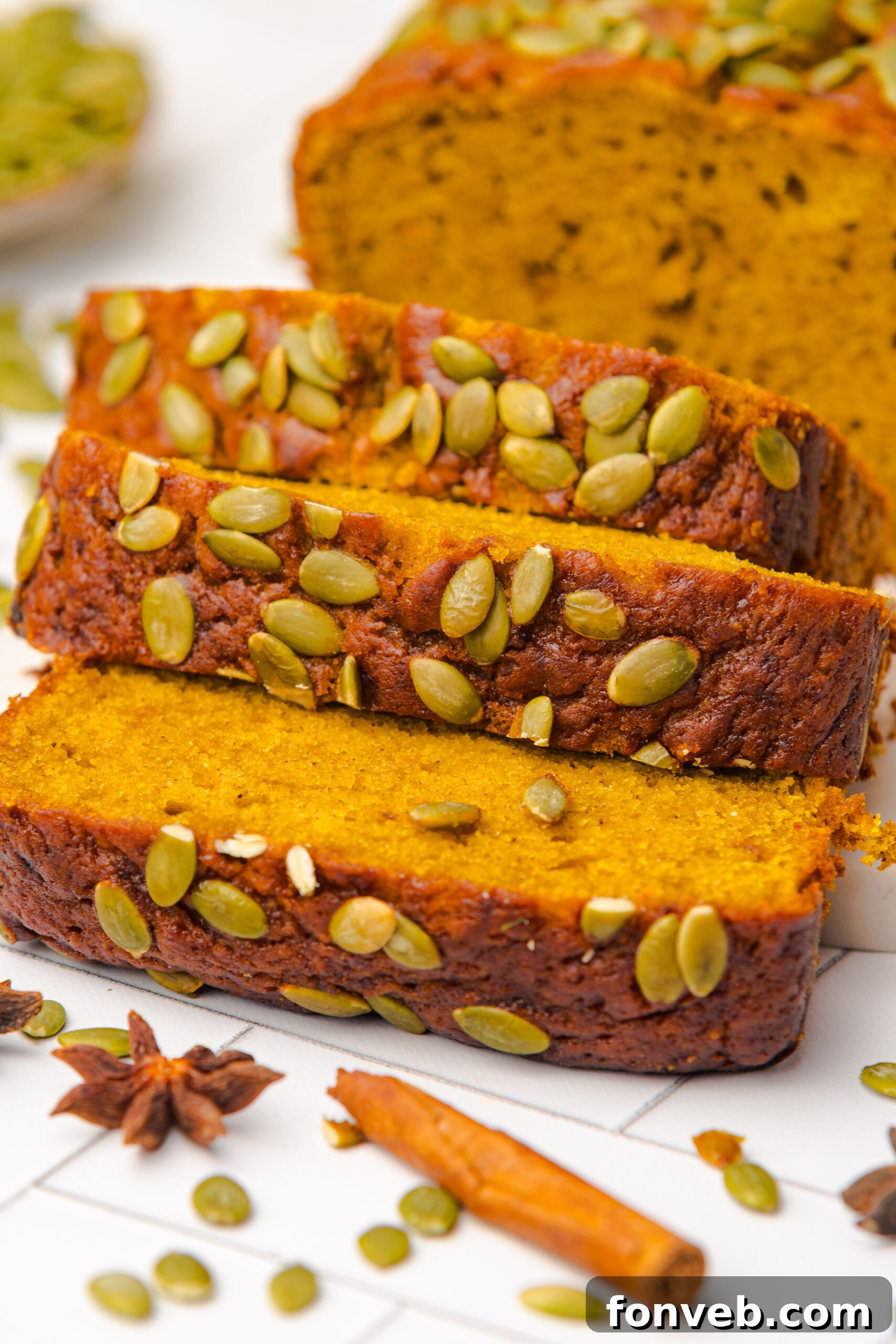 Starbucks Pumpkin Bread   sliced and placed on table with pumpkin seeds on top of each loaf 