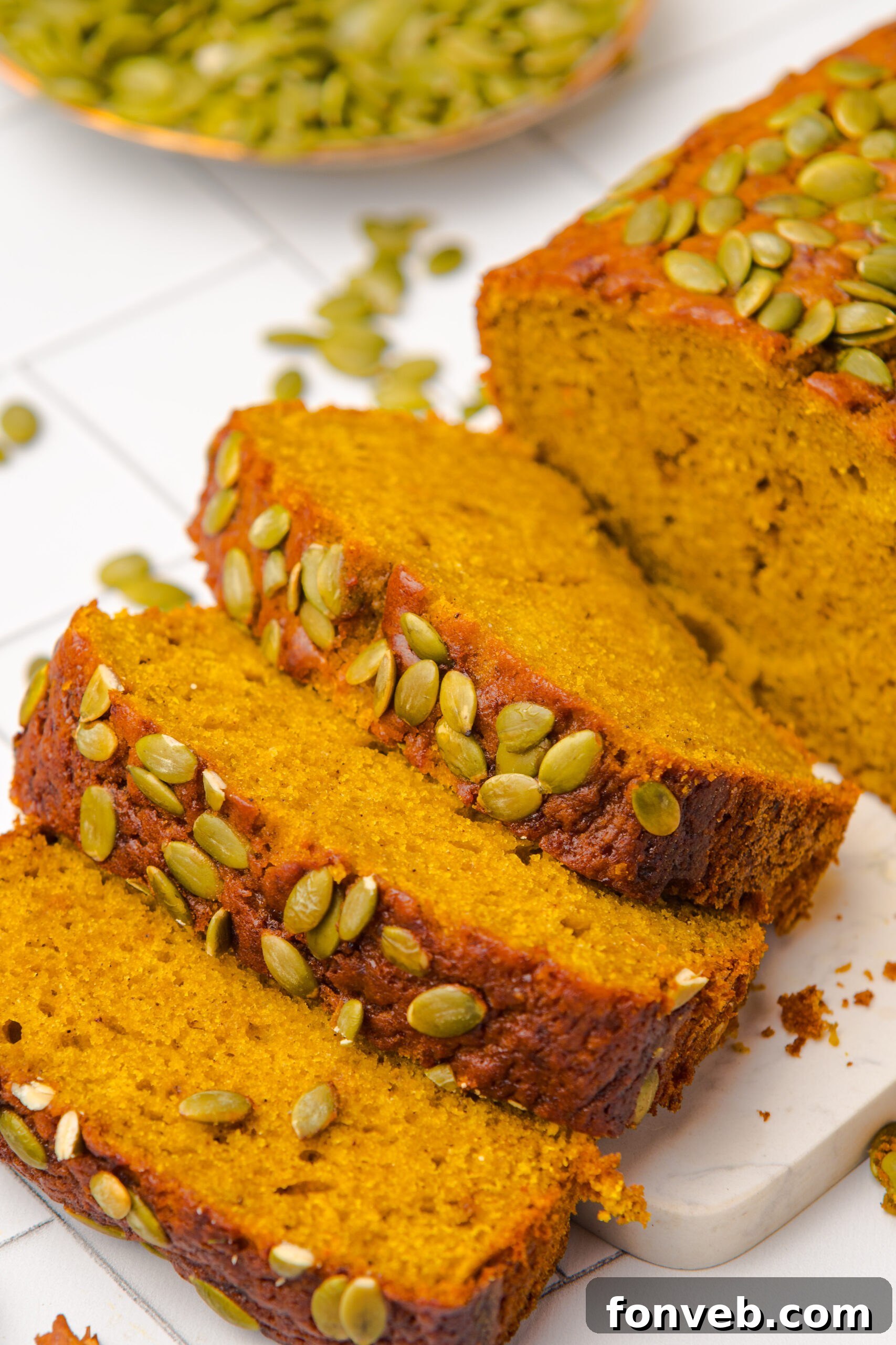 Starbucks Pumpkin Bread   sliced and placed on table with pumpkin seeds on top of each loaf 
