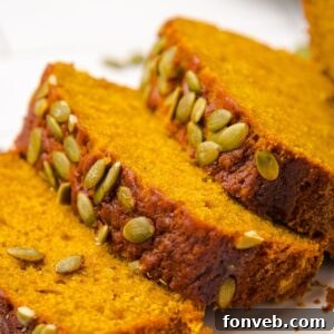 Starbucks Pumpkin Bread sliced and placed on table with pumpkin seeds on top of each loaf