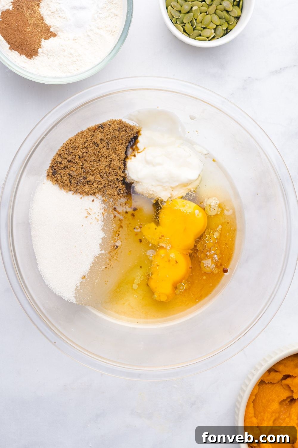 wet ingredients for making homemade Starbucks Pumpkin Bread in a glass bowl on table