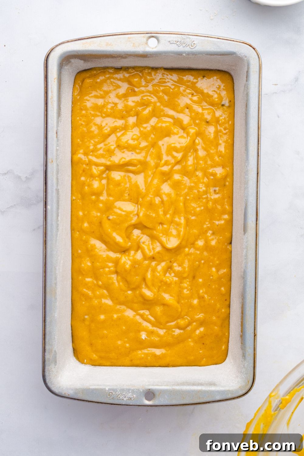 Starbucks Pumpkin Bread batter in a loaf pan on table 