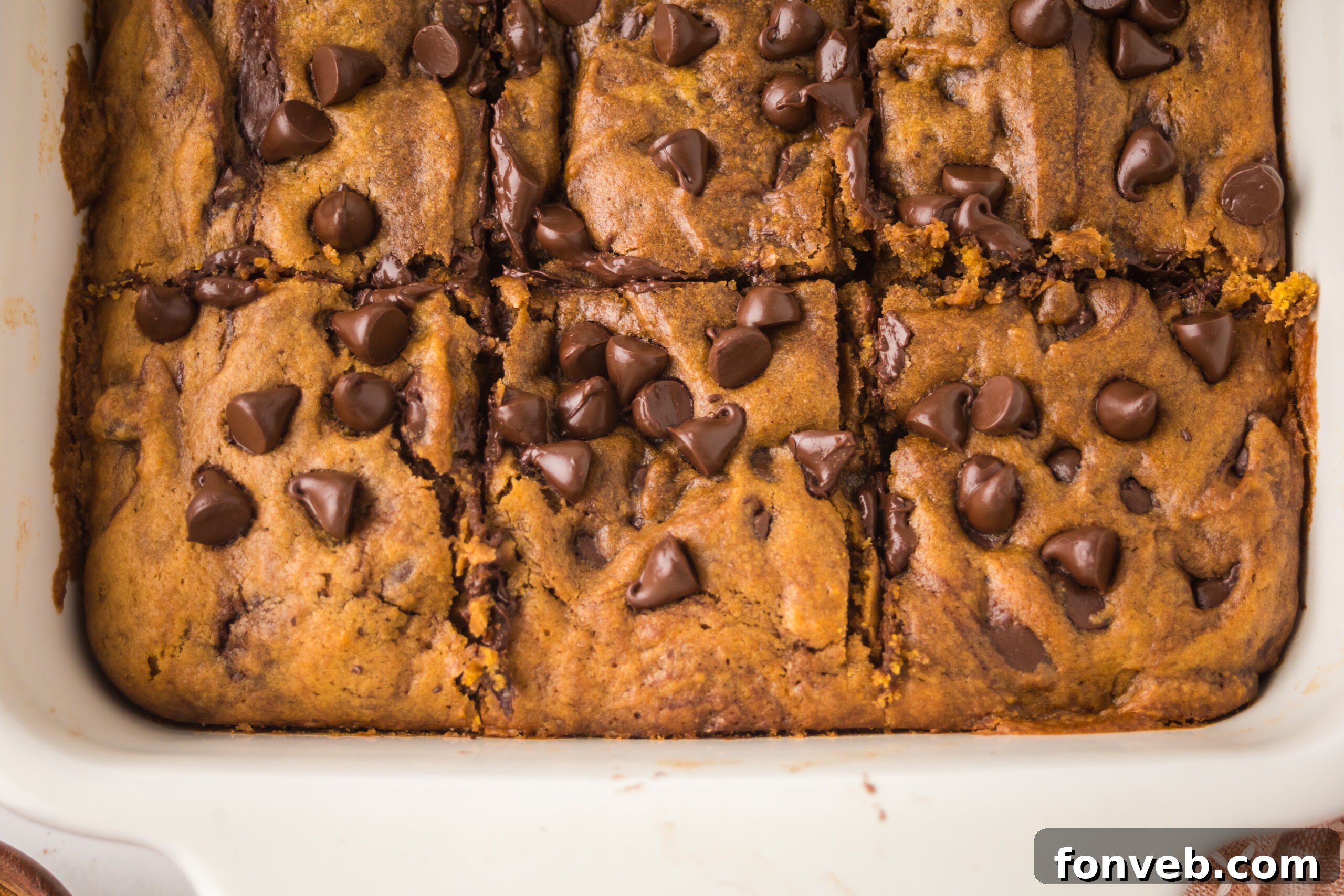 Brown Butter Pumpkin Chocolate Chip Bars in a white baking pan sliced 