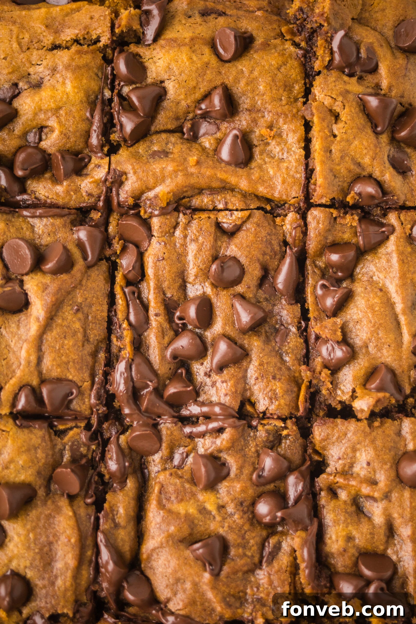 up close and overhead shot of the Brown Butter Pumpkin Chocolate Chip Bars stacked and sliced 