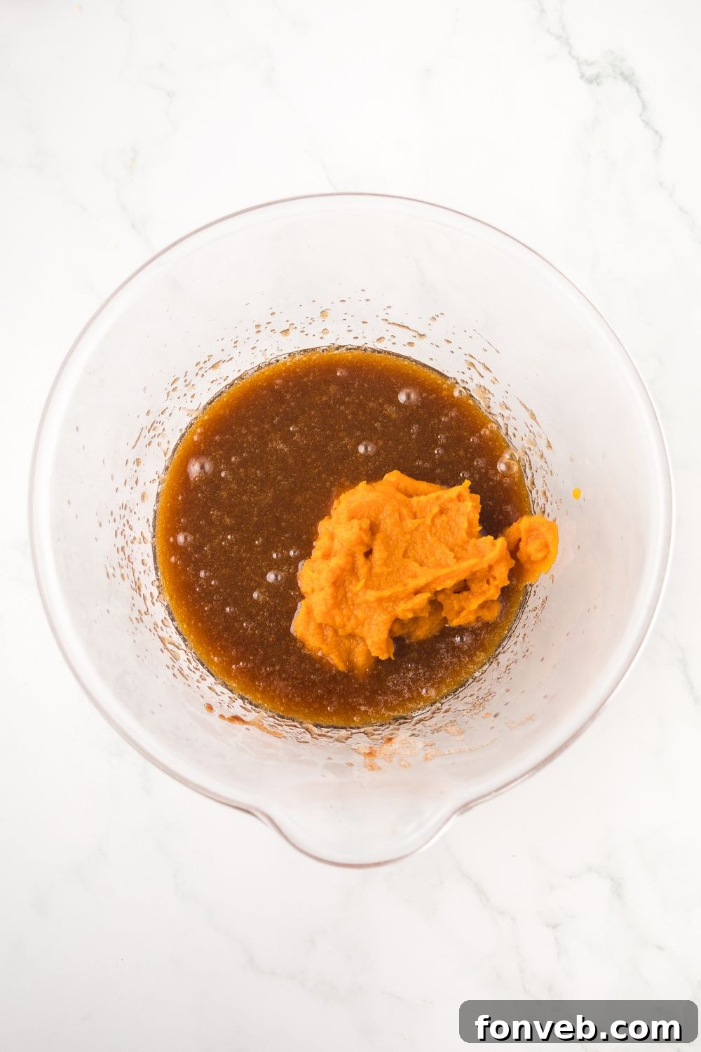 brown butter in a glass bowl with some pumpkin puree as well 