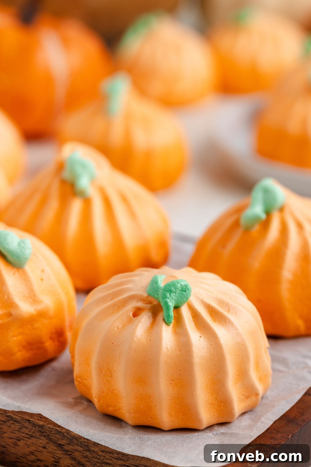 side view of Pumpkin Meringues placed in a single row on tray