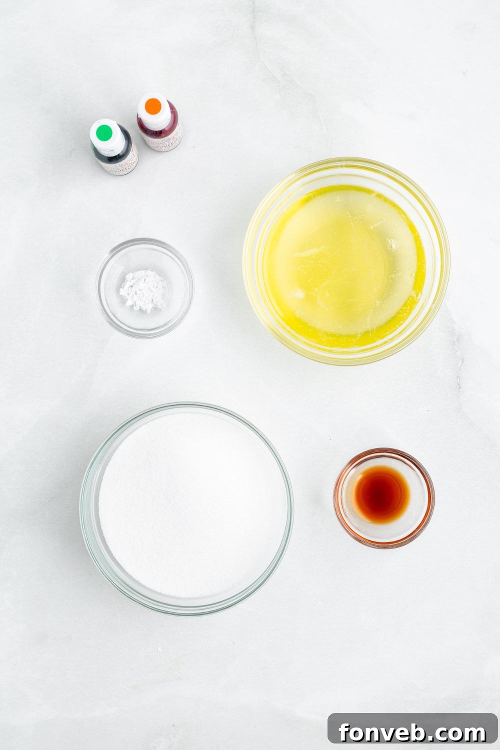 ingredients for making Pumpkin Meringues in glass dishes on a white counter 