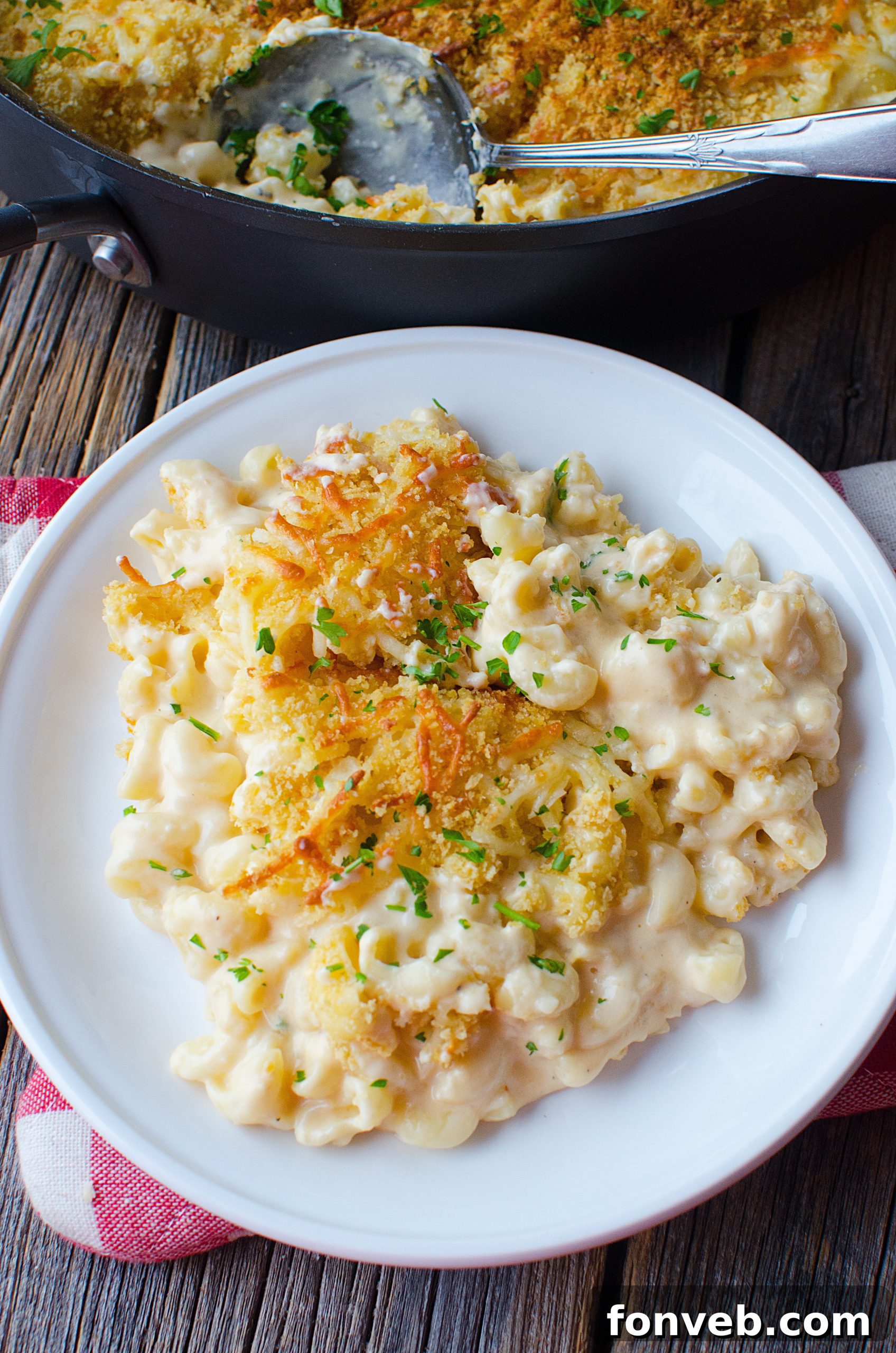 Prepped mac and cheese layers in a baking dish before the final topping and bake