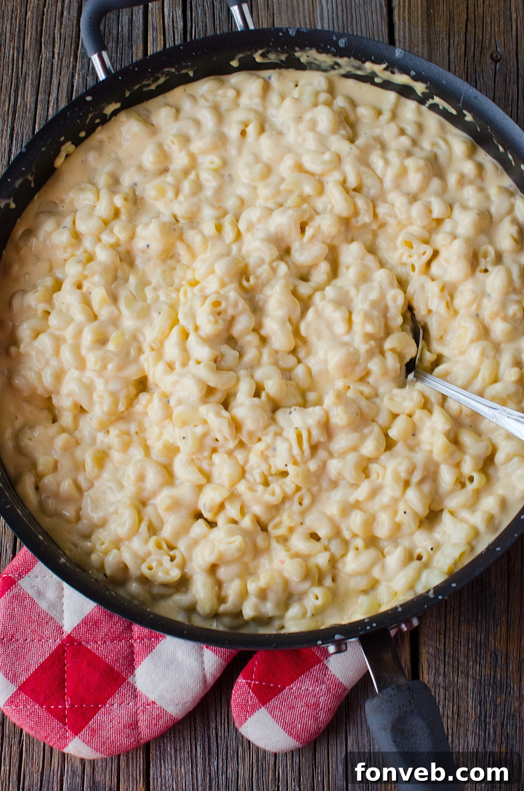Close-up of the creamy texture and cheese pull of the macaroni and cheese