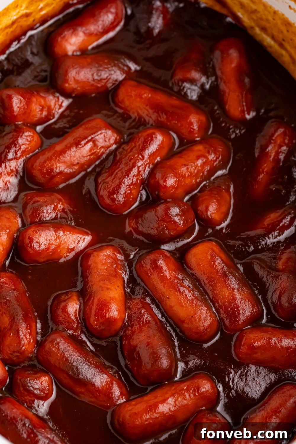 Sweet and Tangy Crockpot Apple Butter Smokies 13 3 ingredient crock pot smokies in a white crockpot
