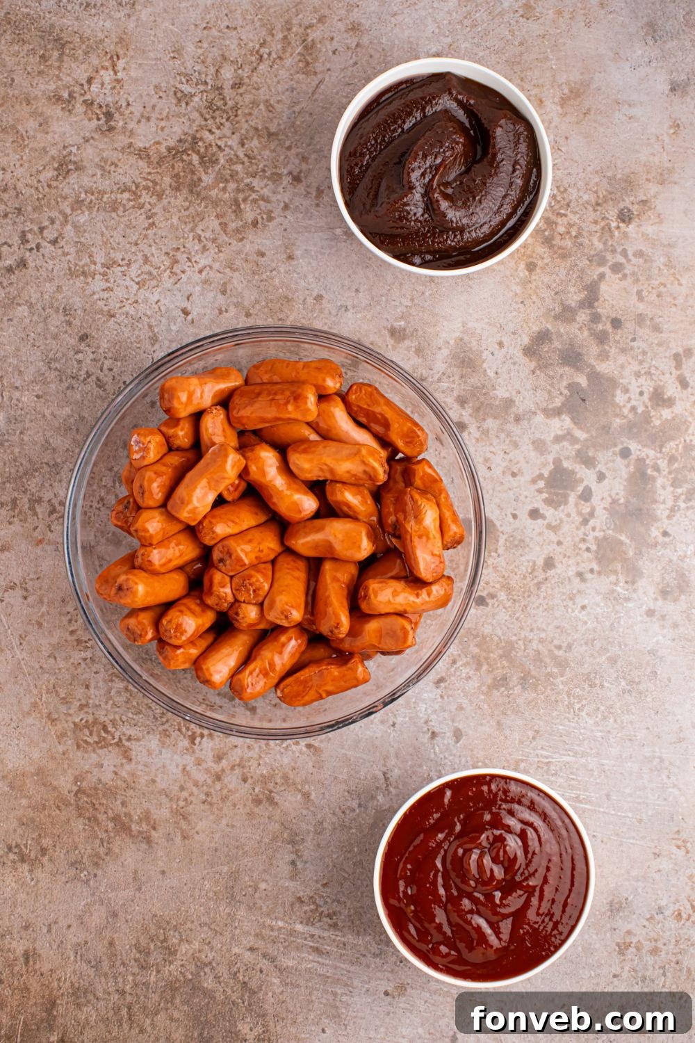 Sweet and Tangy Crockpot Apple Butter Smokies 5 glass bowls with bbq sauce, apple butter, and lil smokies