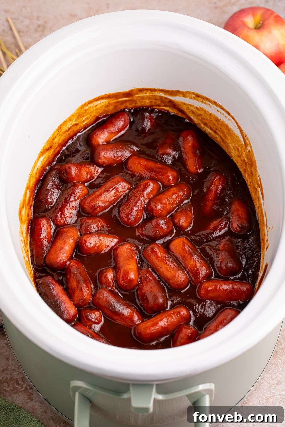 Sweet and Tangy Crockpot Apple Butter Smokies 7 apple butter bbq lil smokies in a white crockpot on the table