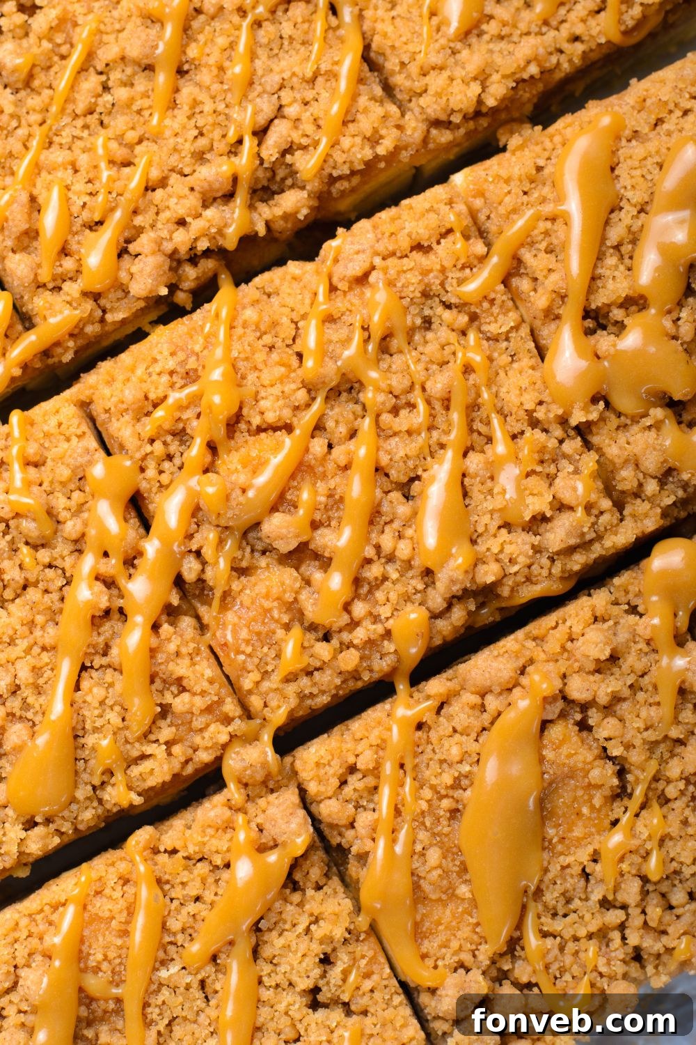 close up to Caramel Apple Pie Bars that are cut into squares drizzled with a bit of caramel