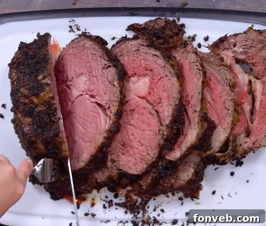 Sliced prime rib showing different levels of doneness, from well-done ends to a pink center