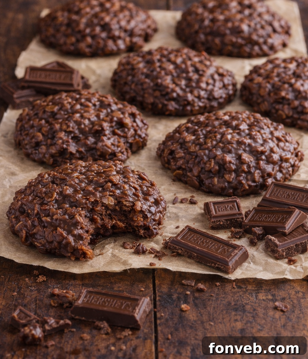 Chocolate Peanut Butter No Bake Cookies on parchment paper with a bite missing from one