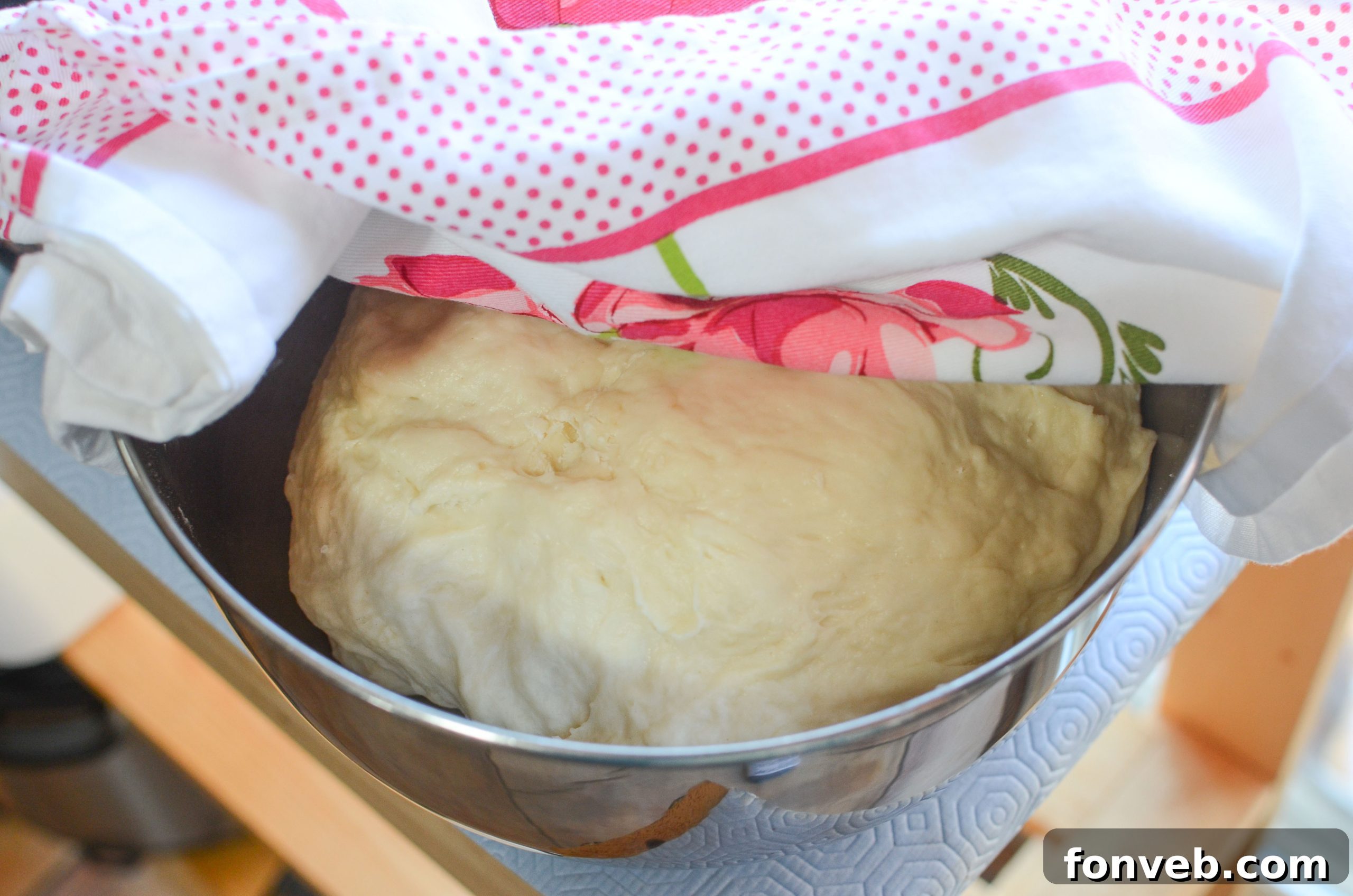 A baking tray filled with round, unbaked dough balls, ready for the oven.