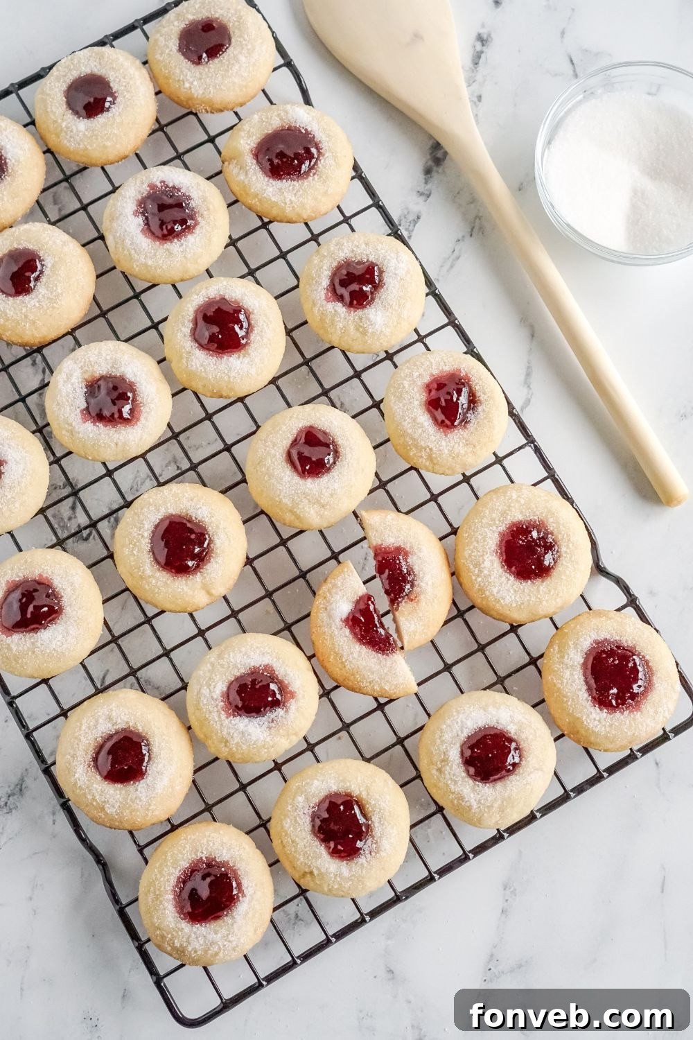 cooling rack with Raspberry Thumbprint Cookies spread out and one cut in half