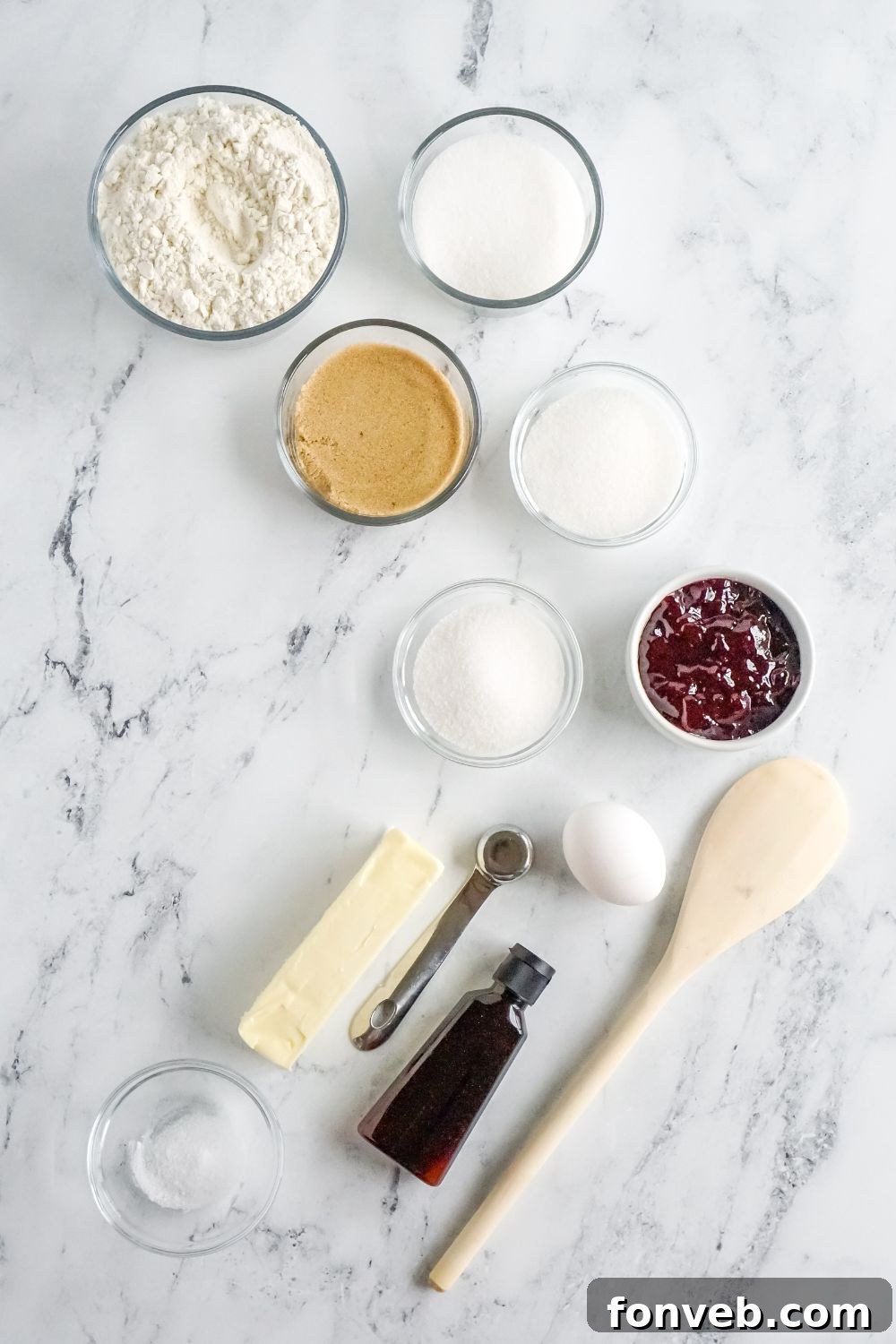 ingredients to make raspberry thumbprint cookies in single serve containers on marble counter