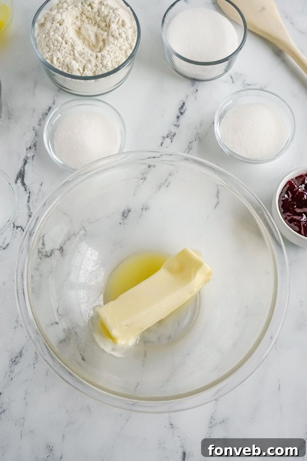 melted butter in a glass bowl on marble counter