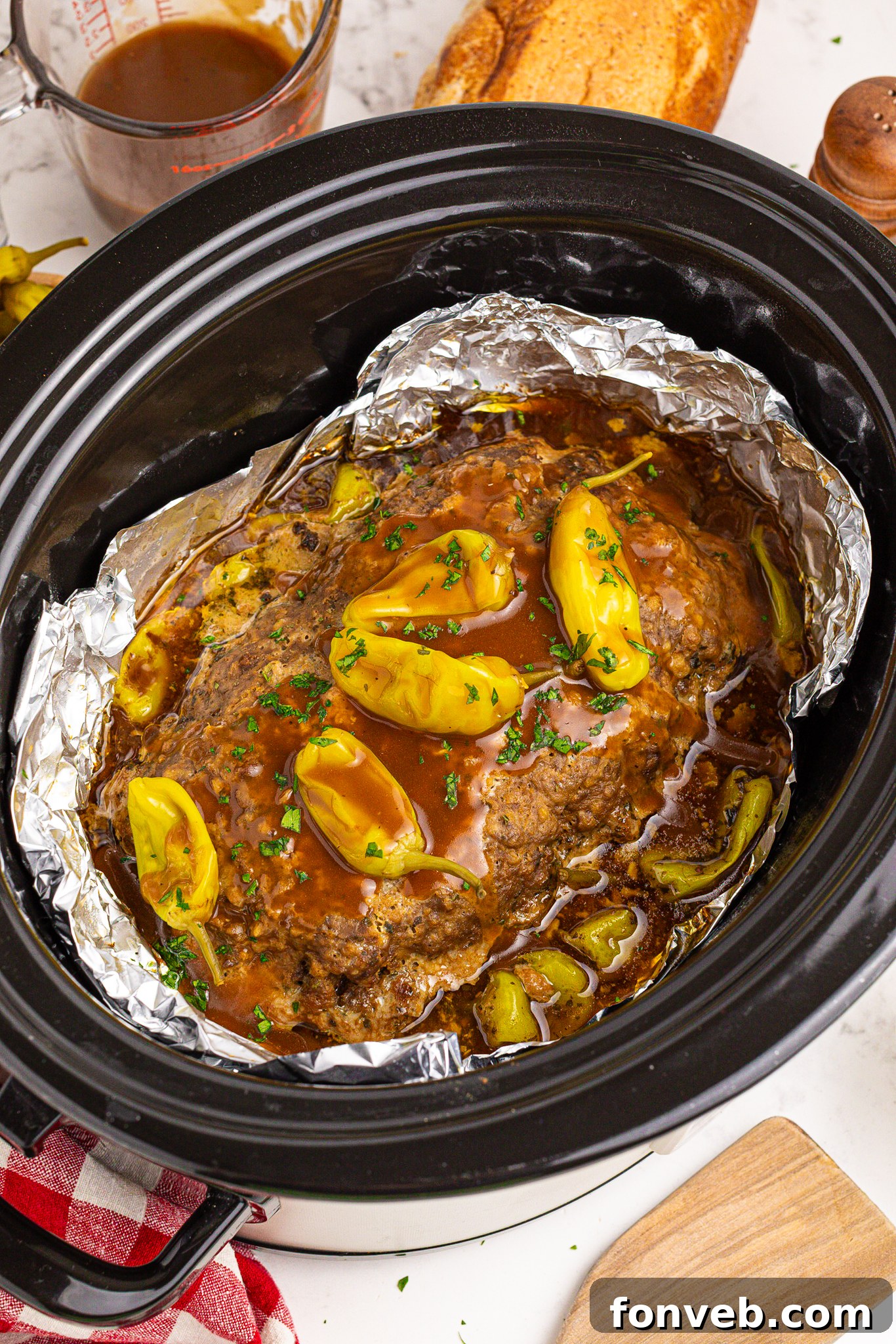 Crockpot Mississippi Meatloaf in a black slow cooker lined with foil 