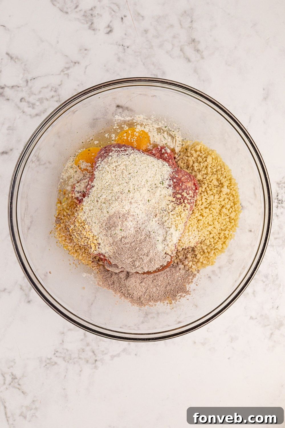 ground beef full of all the seasonings to make Crockpot Mississippi Meatloaf in the bowl on table 