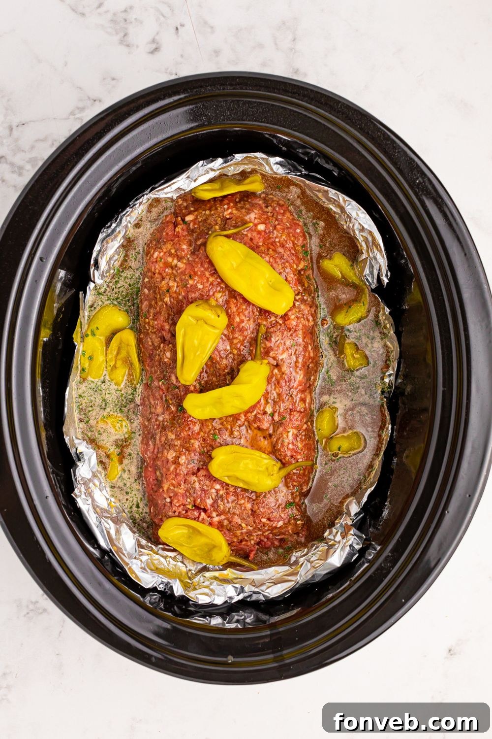 peppers on top of meatloaf in a slow cooker with foil 