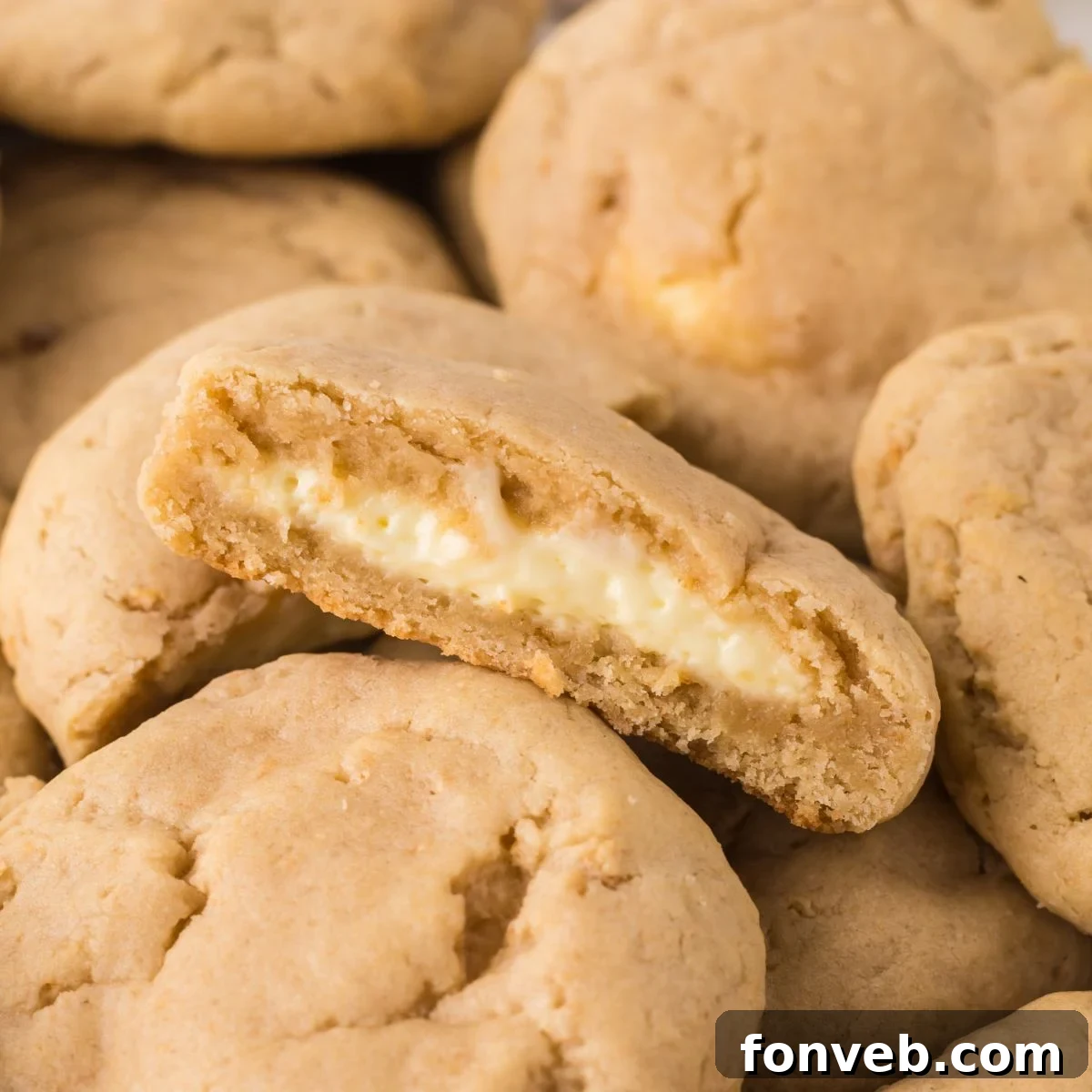 New York Cheesecake Stuffed Cookies spread on table with one cut in half