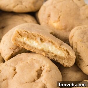 New York Cheesecake Stuffed Cookies spread on table with one cut in half