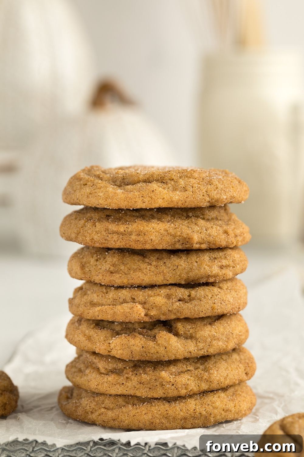 Spiced Pumpkin Snickerdoodle Cookies 13 stack of pumpkin cookies on table with a glass of milk to side on table