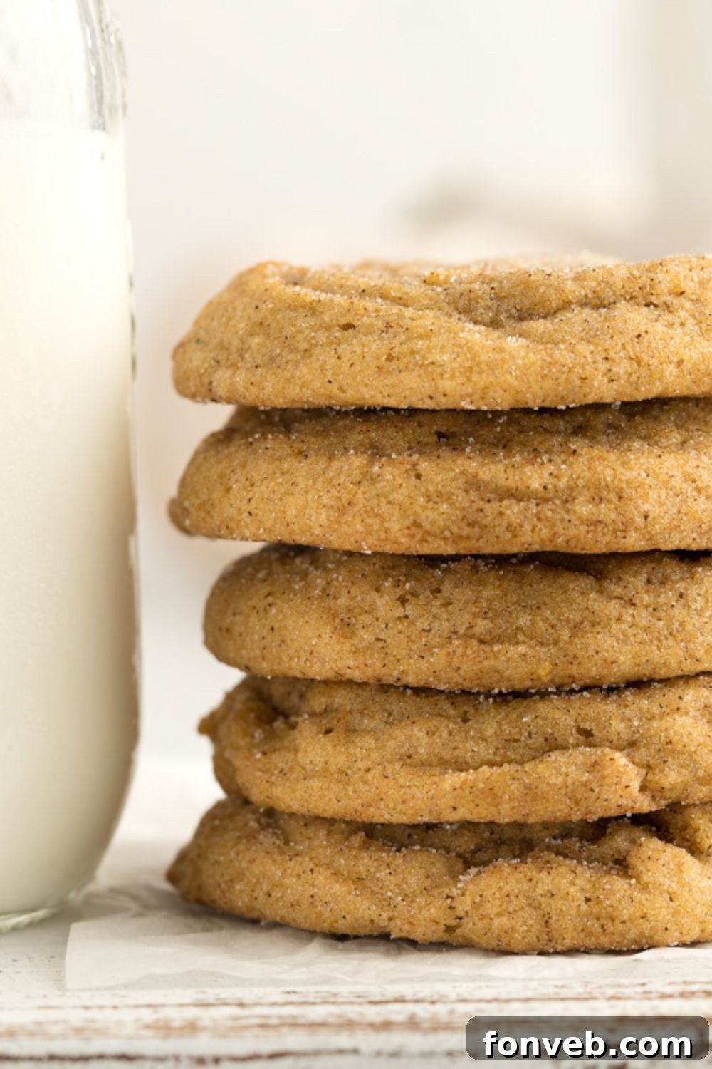 Spiced Pumpkin Snickerdoodle Cookies 14 close up of a stack of pumpkin spice cookies with a glass of milk to side