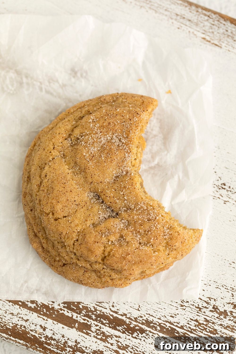 Spiced Pumpkin Snickerdoodle Cookies 15 a pumpkin snickerdoodle sitting on table with a bite taken out of it