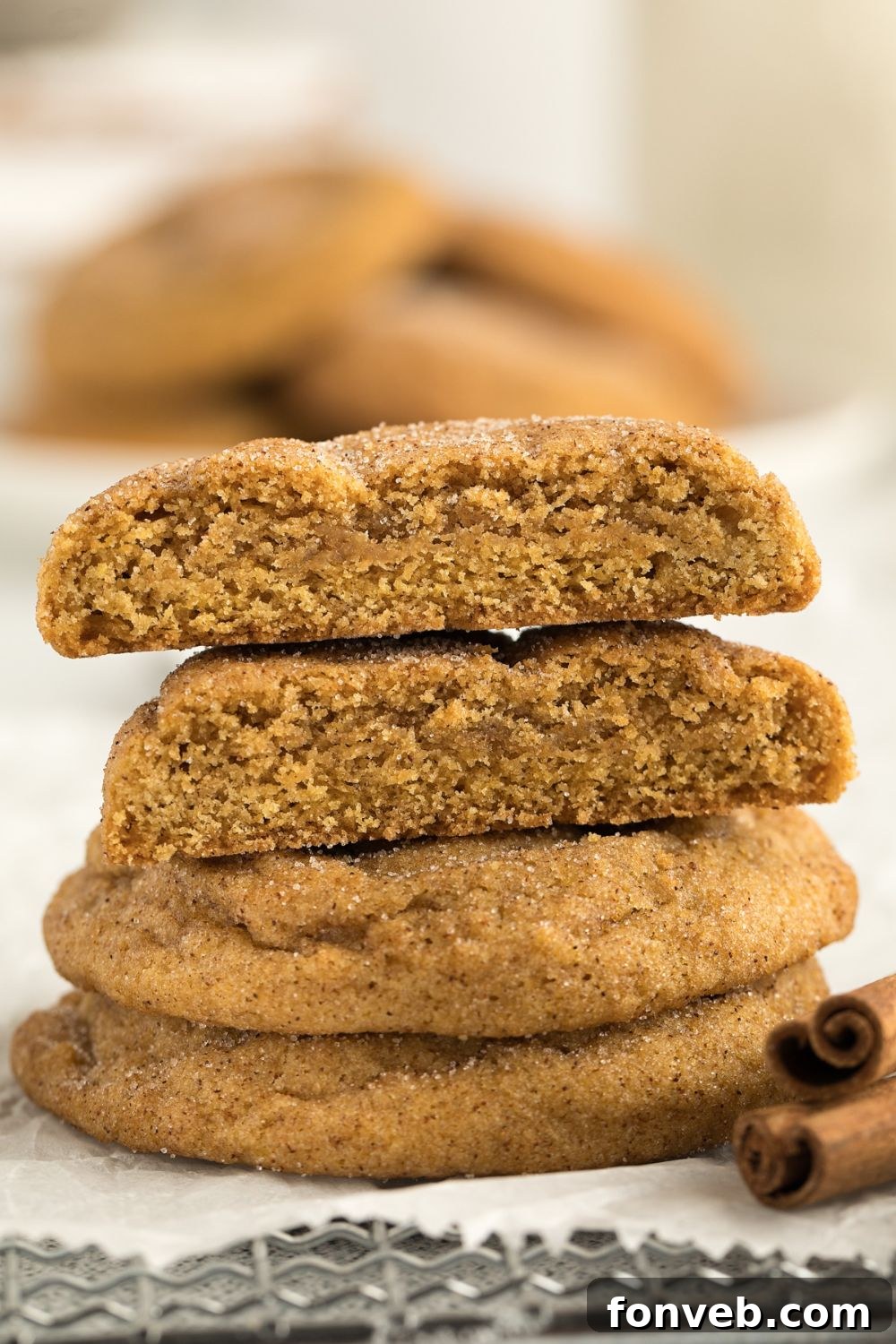 Spiced Pumpkin Snickerdoodle Cookies 20 stack of cookies with the top two cut in half to show how thick and soft the cookies are