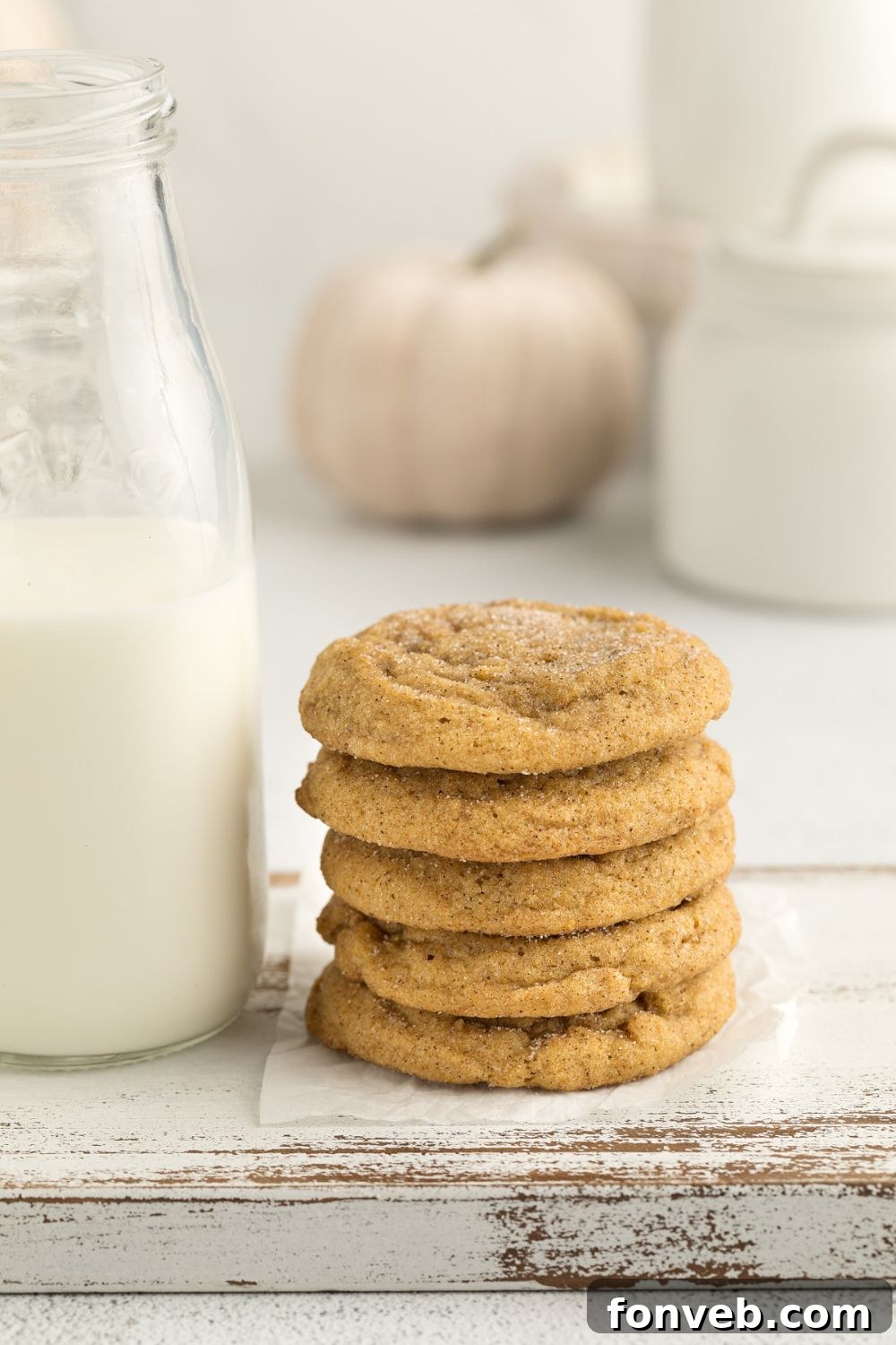Spiced Pumpkin Snickerdoodle Cookies 22 Pumpkin Snickerdoodle Cookies stacked with some milk beside it on table and a white pumpkin in the background