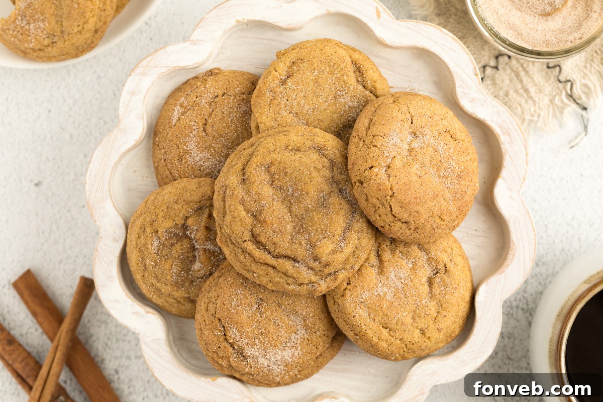 Spiced Pumpkin Snickerdoodle Cookies 24 Pumpkin Snickerdoodle Cookies on a white wooden platter