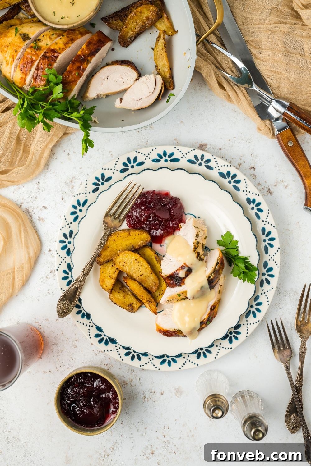 Roasted Turkey Breast on a plate on a table with other holiday sides