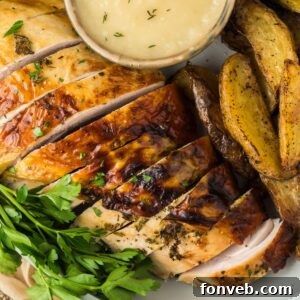 Roasted Turkey Breast on plate with potatoes and a dipping sauce to the side
