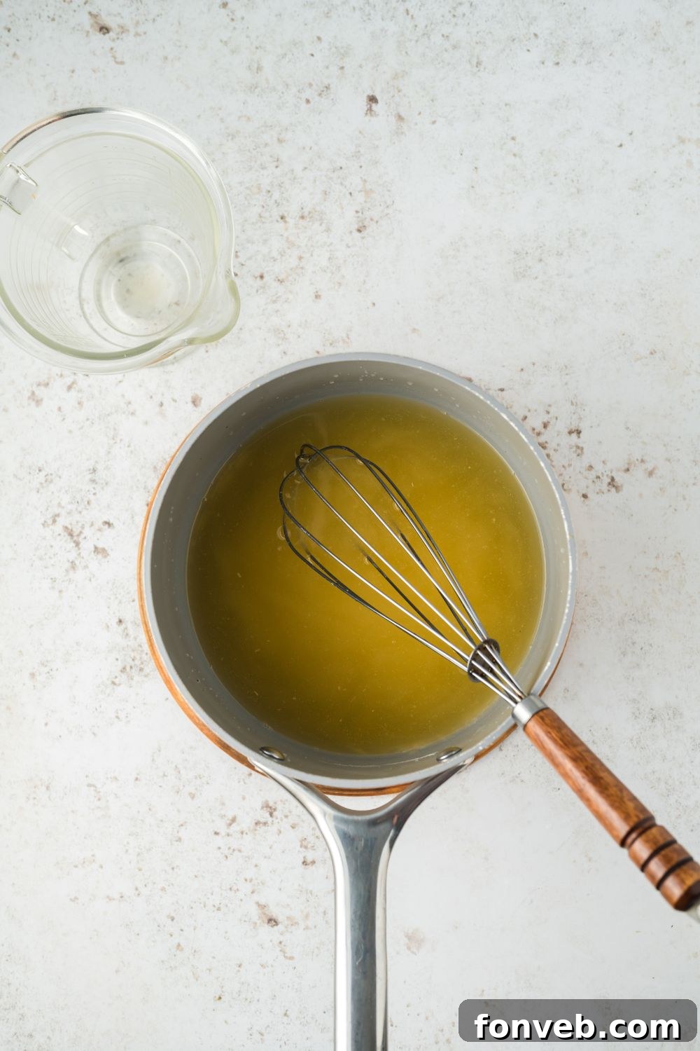 Small pan on a marble counter making a gravy for turkey