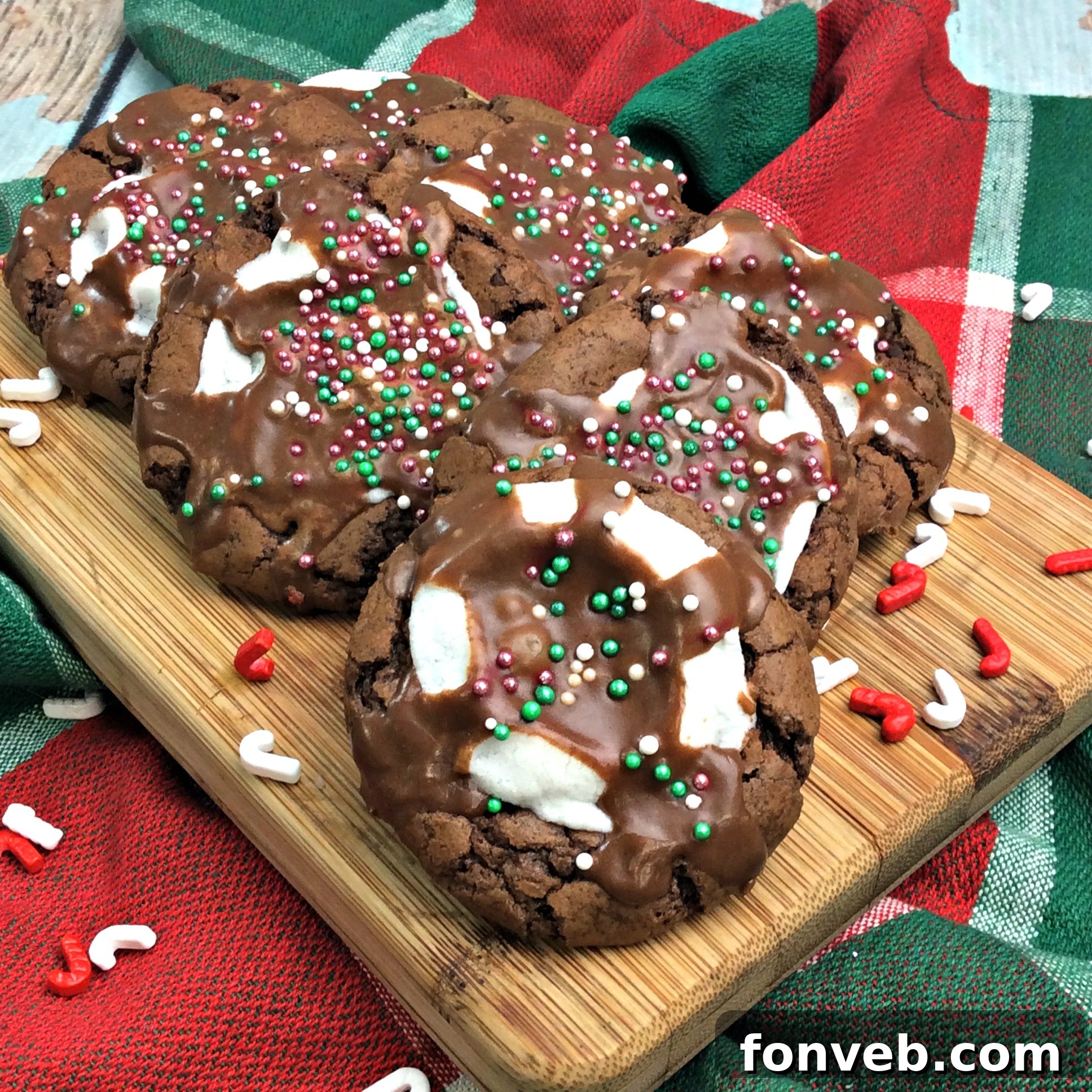 Close-up of baked hot cocoa marshmallow cookies with melted marshmallows, ready for icing