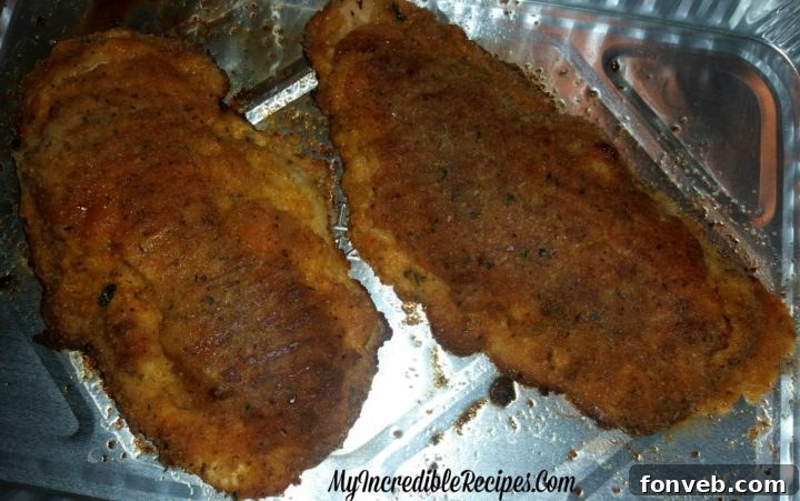 Cooked boneless chicken cutlets in a baking dish