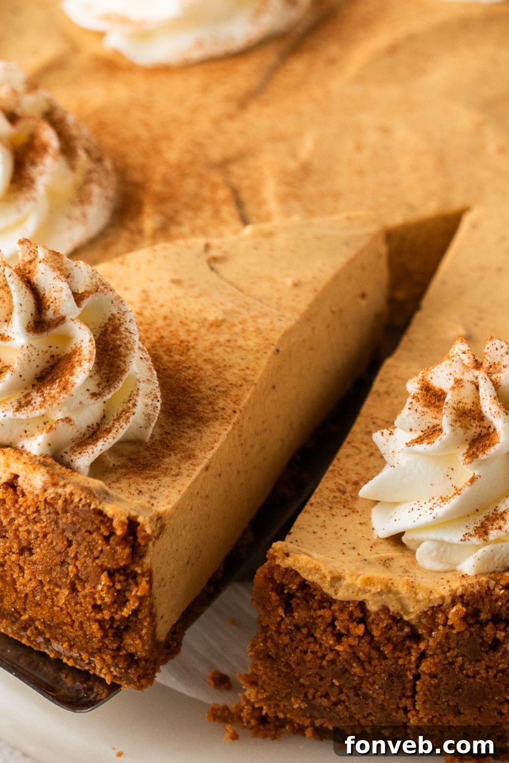 slice of No Bake Gingerbread Cheesecake being lifted off the pie plate