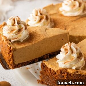 No Bake Gingerbread Cheesecake on a platter with one slice lifting out of the pie plate