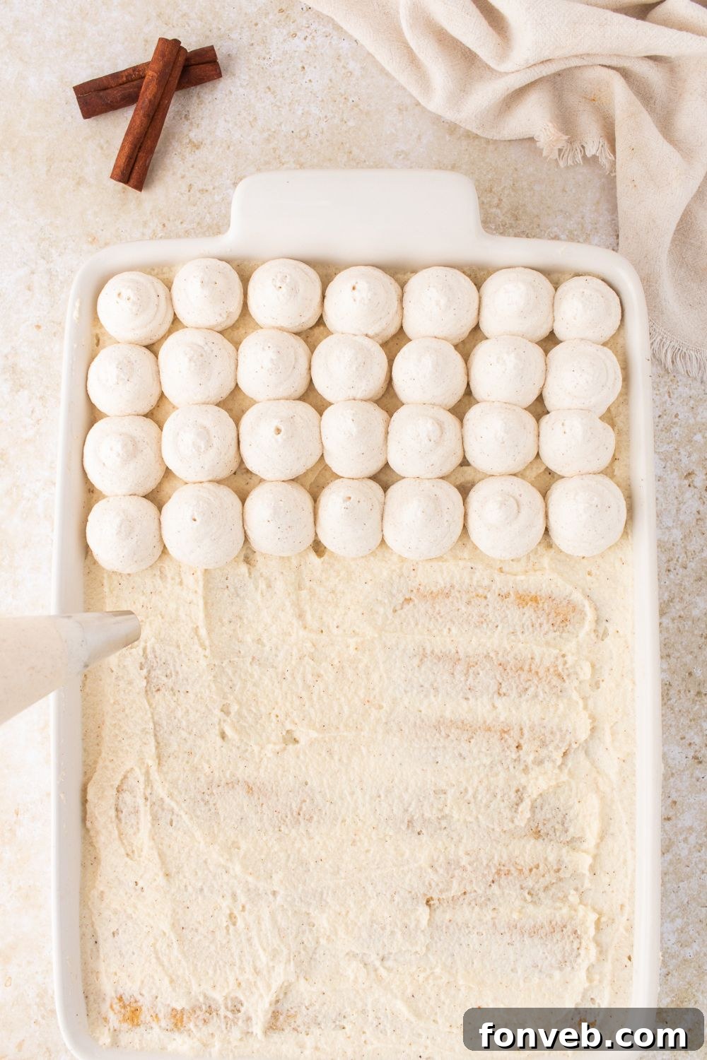 piping topping on top of the Eggnog Tiramisu