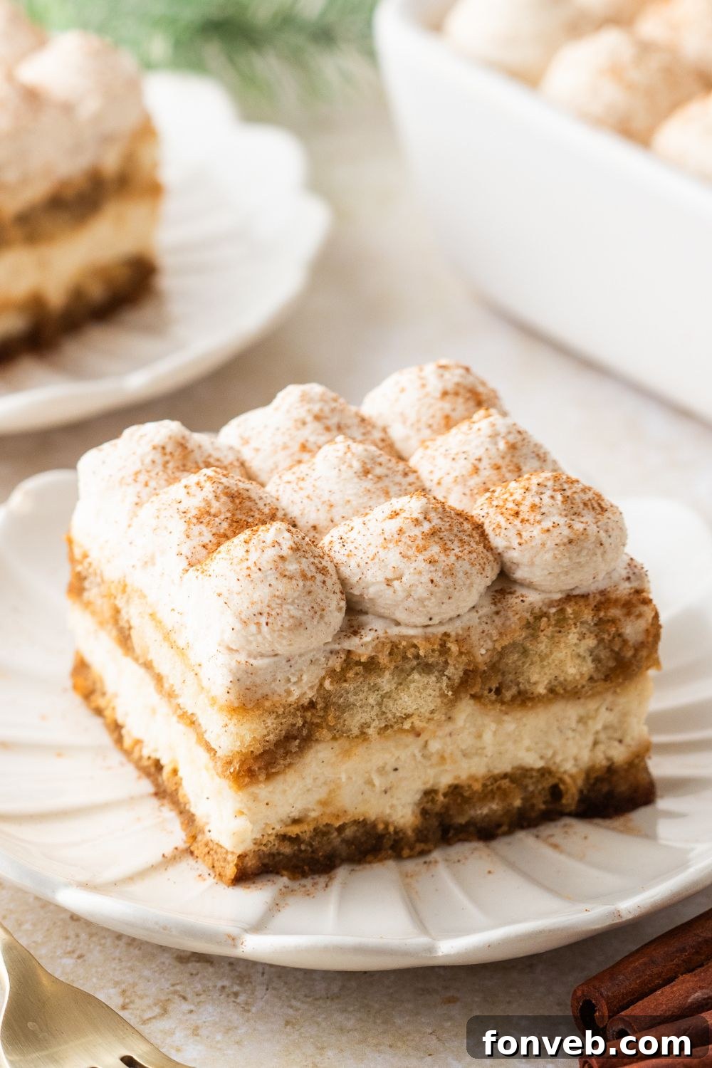 pan full of tiramisu with plates around table with slices of the tiramisu